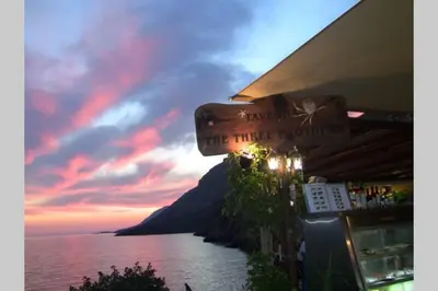 a sign that reads the third world at sunset at Great sea-view apartment. in Khóra Sfakíon
