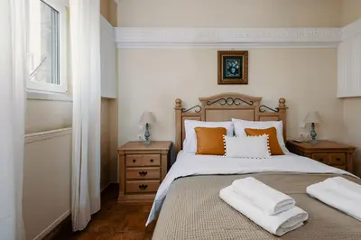 a bedroom with a bed with two pillows on it at Villa Paparouna in Chania Town