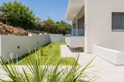 a garden with a white fence next to a house at Kallistefan in Kissamos