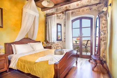 a bedroom with a bed and a large window at Samonas - Blue villa Mantzourana in Khiliomoudhoú