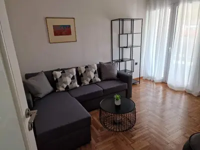 a living room with a couch and a table at CENTRAL ROOF NK CHANIA in Chania Town