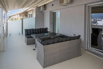 a living room with two couches and a table at CENTRAL ROOF NK CHANIA in Chania Town