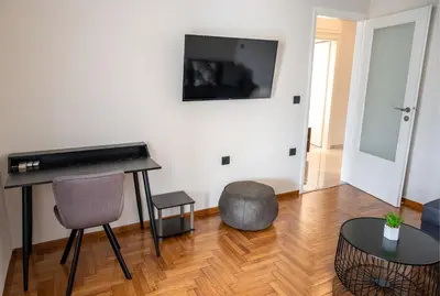 a living room with a piano and a table at CENTRAL ROOF NK CHANIA in Chania Town
