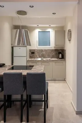 a kitchen with a table and chairs and a sink at CENTRAL ROOF NK CHANIA in Chania Town