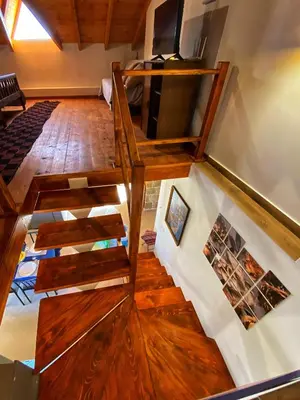 an overhead view of a staircase in a room with wooden floors at DESTAN & JULIETTE SEA VIEW Villa in Kamisianá
