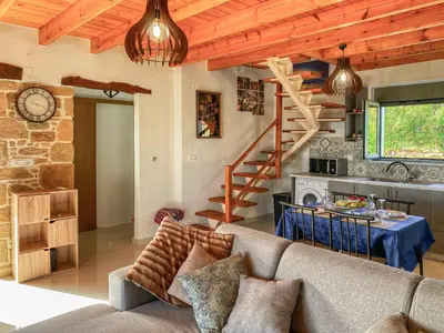 a living room with a couch and a table at DESTAN & JULIETTE SEA VIEW Villa in Kamisianá