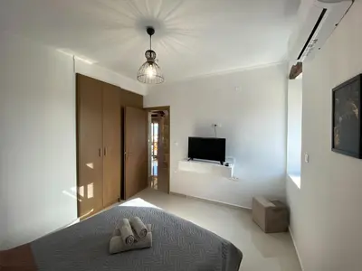 a bedroom with a bed with two slippers on it at DESTAN & JULIETTE SEA VIEW Villa in Kamisianá