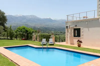 a swimming pool in the backyard of a house at Villa Elia by PosarelliVillas in Vryses