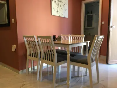 a dining room with a table and four chairs at Πολυτελές οροφοδιαμέρισμα για ονειρικές διακοπές! in Chania Town