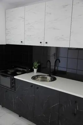 a kitchen with a sink and a stove at Πολυτελές οροφοδιαμέρισμα για ονειρικές διακοπές! in Chania Town