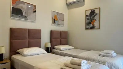 two beds in a room with two bedsvisor at Άνετο και πολυτελές οροφοδιαμέρισμα 2 in Chania Town