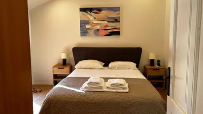 a bedroom with a bed with two towels on it at Άνετο και πολυτελές οροφοδιαμέρισμα 2 in Chania Town