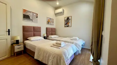 two beds in a small room with at Άνετο και πολυτελές οροφοδιαμέρισμα 2 in Chania Town