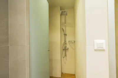 a shower in a bathroom with a glass door at Villy Luxury Home by the Sea 1 in Ayiá