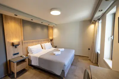 a bedroom with a white bed and a table at Villy Luxury Home by the Sea 2 in Ayiá