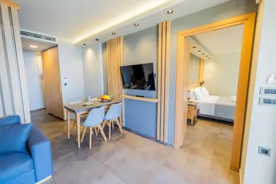 a living room with a couch and a table and a bed at Villy Luxury Home by the Sea 2 in Ayiá