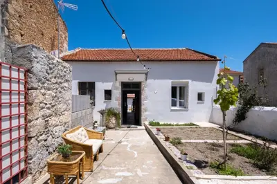 a small white house with a pathway leading to it at Jasmine Home by the Sea by 8essentially in Kalyves