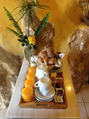 a tray with cups of coffee and oranges on a table at Samonas - Orange villa Diktamos in Khiliomoudhoú