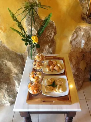 a table with three trays of food on it at Samonas - Orange villa Diktamos in Khiliomoudhoú