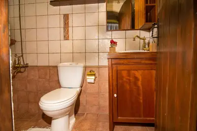 a small bathroom with a toilet and a sink at Samonas - Orange villa Diktamos in Khiliomoudhoú