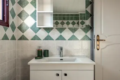 a bathroom with a sink and a mirror at ApteraMare Tradidtional house 'New listing' in Chania Town