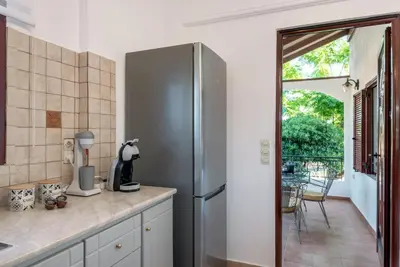 a kitchen with a stainless steel refrigerator and a patio at ApteraMare Tradidtional house 'New listing' in Chania Town