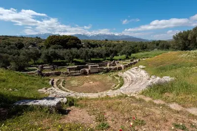 an old stone building in a field with mountains in the background at ApteraMare Tradidtional house 'New listing' in Chania Town