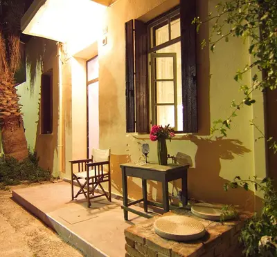 a patio with a table and chairs and a window at Auntie's home by Chania Old Harbor in Chania Town