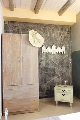 a bedroom with a large wooden cabinet and a table at Auntie's home by Chania Old Harbor in Chania Town