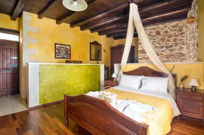 a bedroom with a bed with a mosquito net at Samonas - Green villa Faskomilia in Chania Town