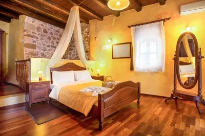 a bedroom with a bed and a large mirror at Samonas - Green villa Faskomilia in Chania Town