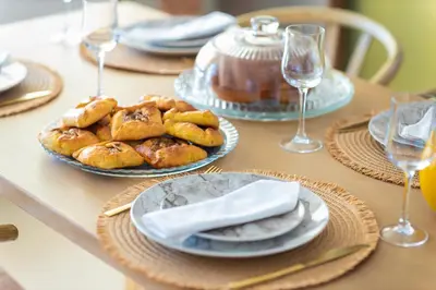 a table with plates of pastries and wine glasses at Casa dei Sogni in Nerokoúros