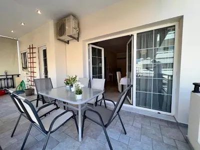 a dining room table and chairs in a house at Central apartment in quiet neighborhood near sandy beach in Chania Town