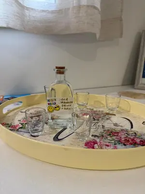a tray with glasses and a bottle on a table at The house of JohnKou in Chania Town