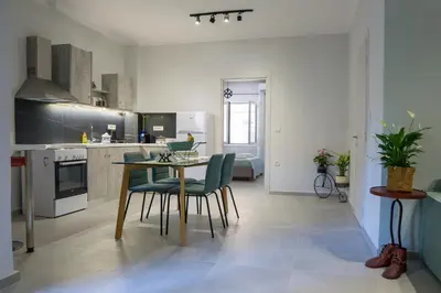a kitchen and dining room with a table and chairs at The house of JohnKou in Chania Town