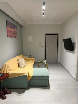 a bedroom with a bed and a flat screen tv at The house of JohnKou in Chania Town