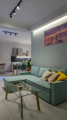a living room with a blue couch and a table at The house of JohnKou in Chania Town