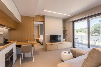 a living room with a couch and a television at Noemie Luxury Suites in Chania Town