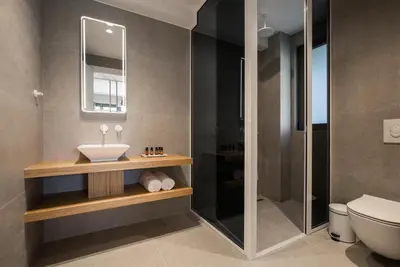 a bathroom with a sink and a shower at Noemie Luxury Suites in Chania Town