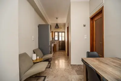 a hallway with chairs and a table in a room at Casa Armonia Seaside by 8essentially in Chania Town