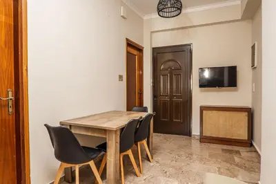 a dining room with a wooden table and chairs at Casa Armonia Seaside by 8essentially in Chania Town