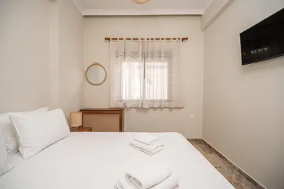 a bedroom with a white bed with towels on it at Casa Armonia Seaside by 8essentially in Chania Town