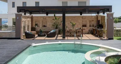 a swimming pool in a yard with a patio at Villa Peacock with Spa Facilities in Daratso