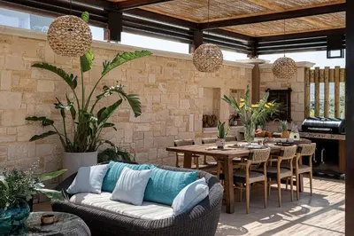 a patio with a couch and a table and chairs at Villa Peacock with Spa Facilities in Daratso