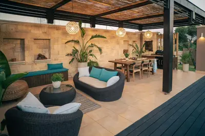 a patio with couches and chairs and a table at Villa Peacock with Spa Facilities in Daratso