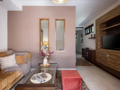 a living room with a couch and a tv at Villa Peacock with Spa Facilities in Daratso