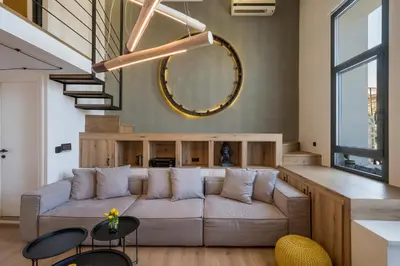 a living room with a couch and a mirror at Skins Concept Boutique Apartment in Chania Town