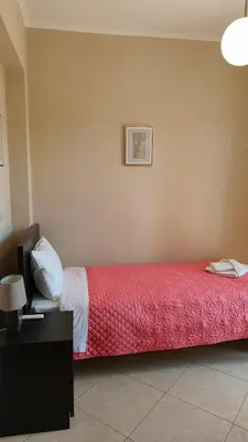 a bedroom with a bed with a red blanket at Pazinos/Neveli Cottage in Galangádhos