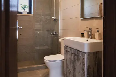 a bathroom with a sink and a toilet and a shower at Villa Olive Valley in Loutrákion