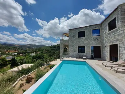 a villa with a swimming pool and a house at Villa Olive Valley in Loutrákion